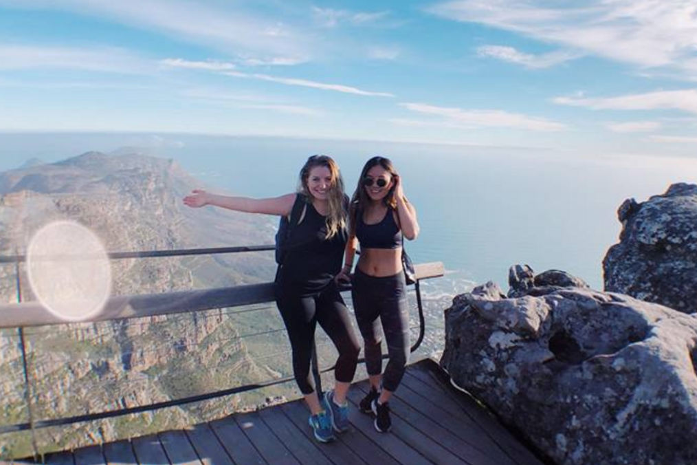 2 hikers smiling at a view point